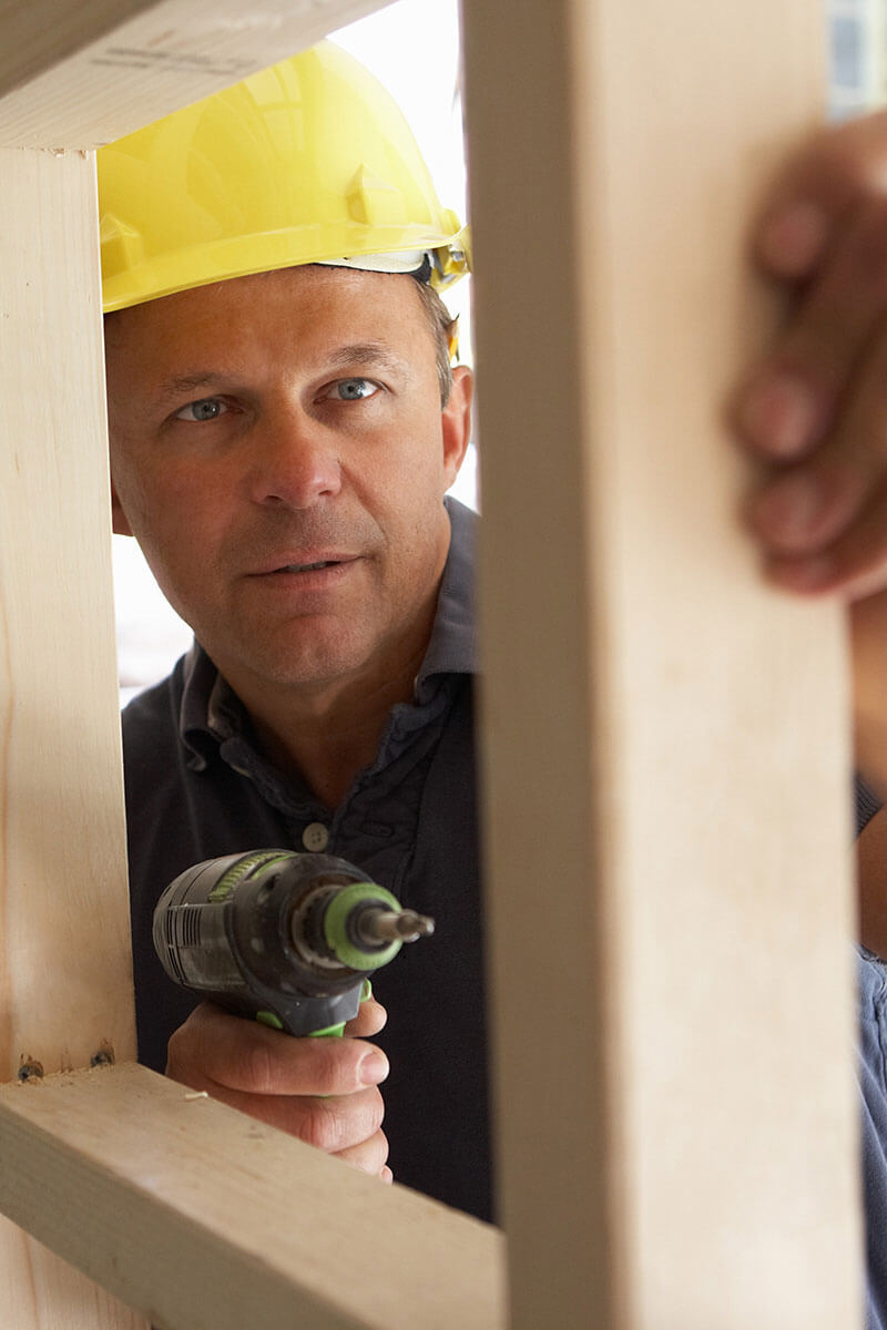 Construction worker inspecting work.