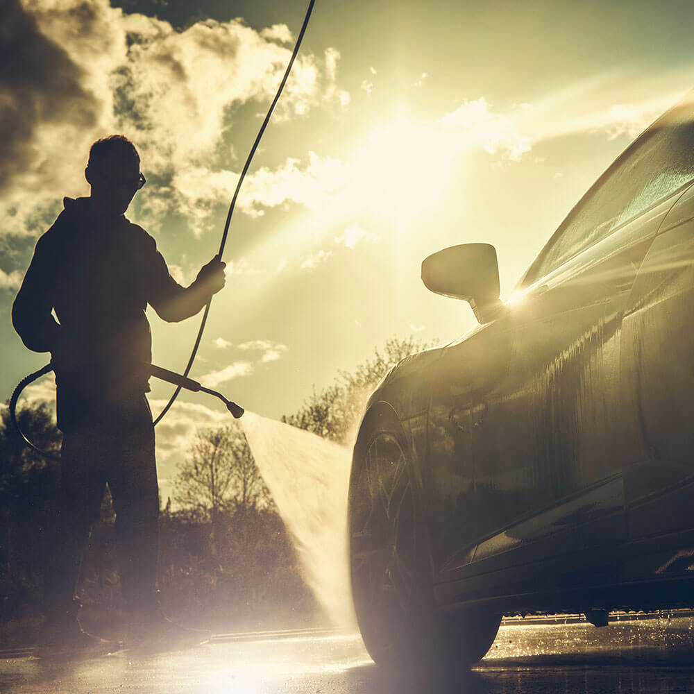 Person cleaning an exotic car