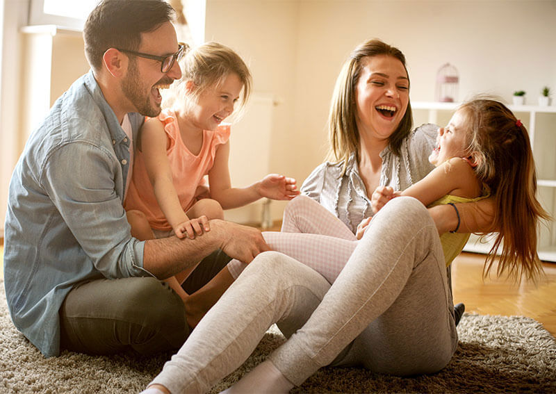 Father and mother playing with their children