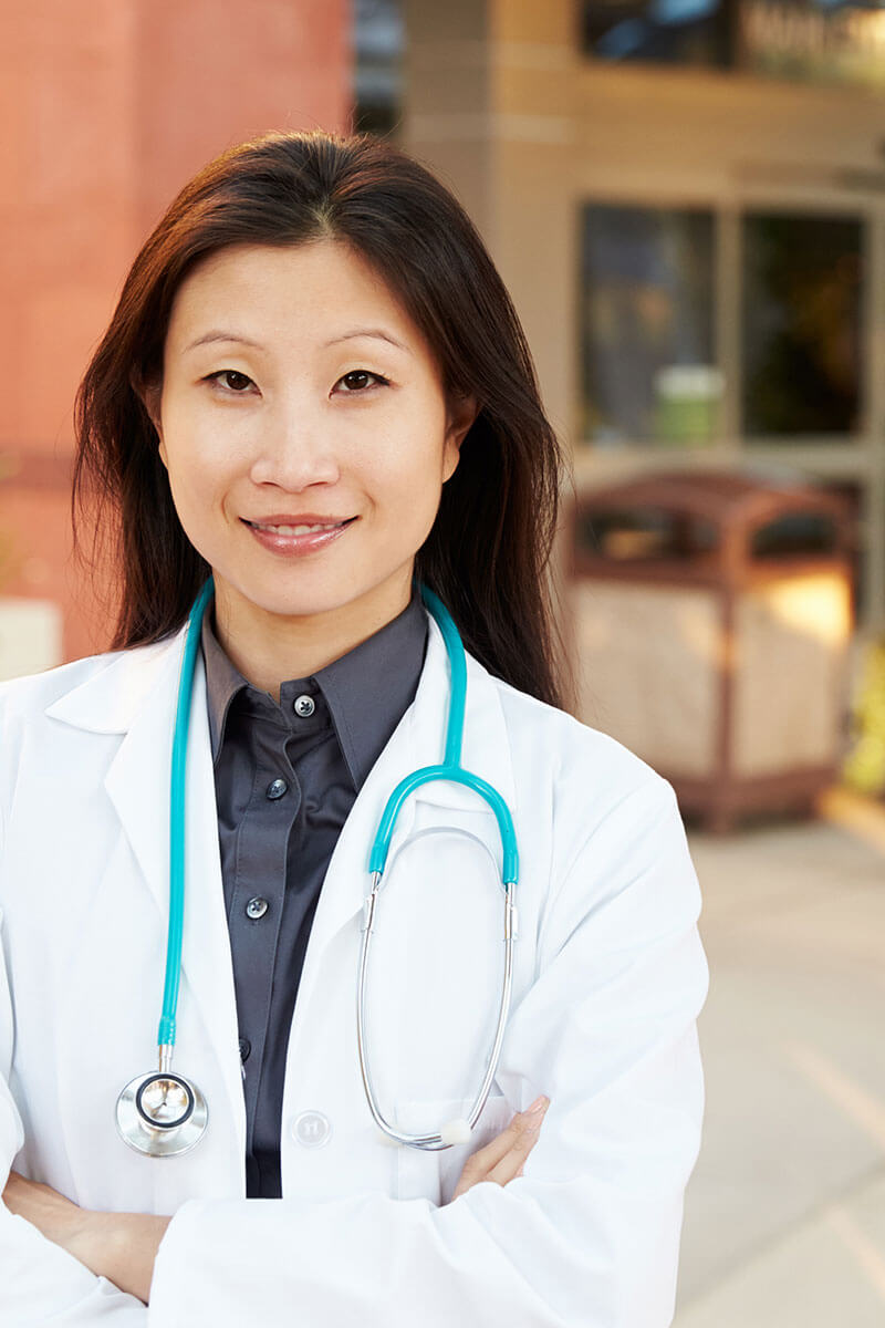 Patient and doctor outside of medical building