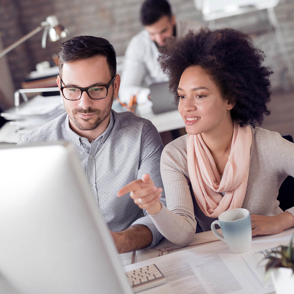 Man and woman looking at a computer