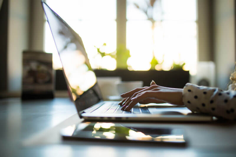 Hands typing at a computer