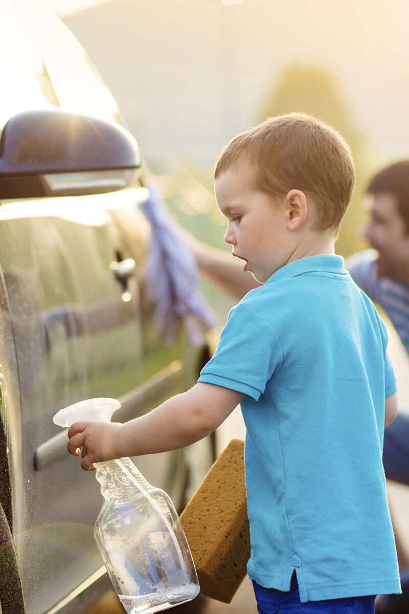 Kid washing a car