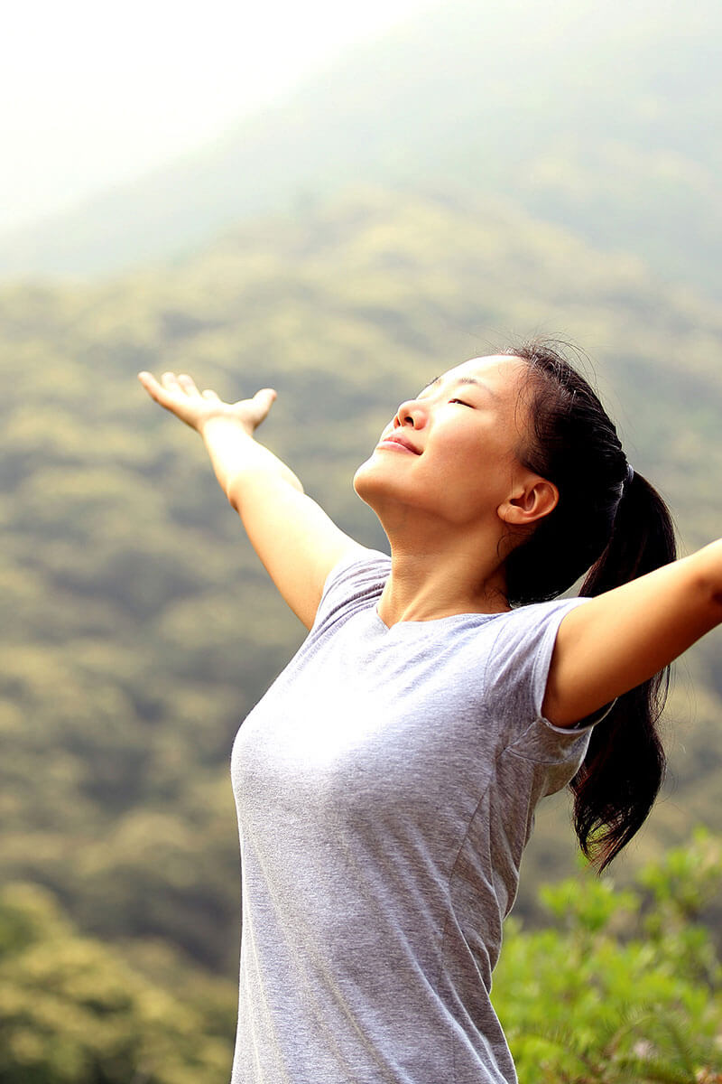 Person raising their arms to the sky