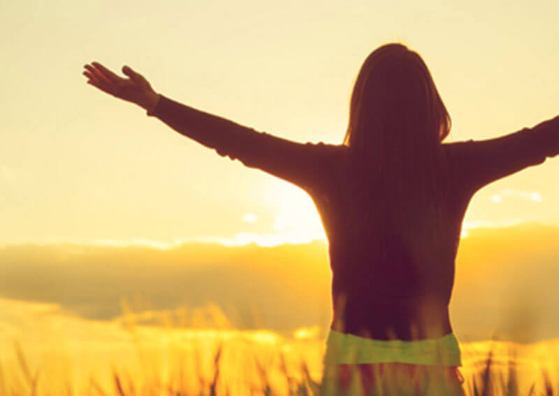 Person raising their arms to the sky